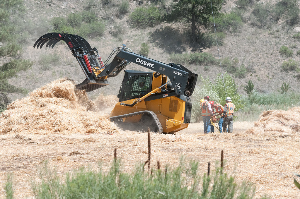 Heavy equipment working through brush during a land clearing job